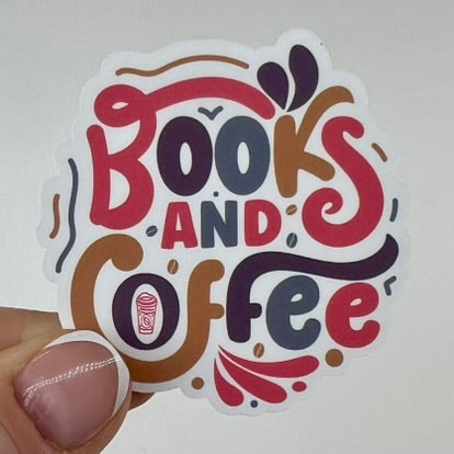 A vinyl sticker with the phrase 'Books and Coffee' written in stylized lettering, featuring colors red, brown, and blue, with a small illustration of a coffee cup.