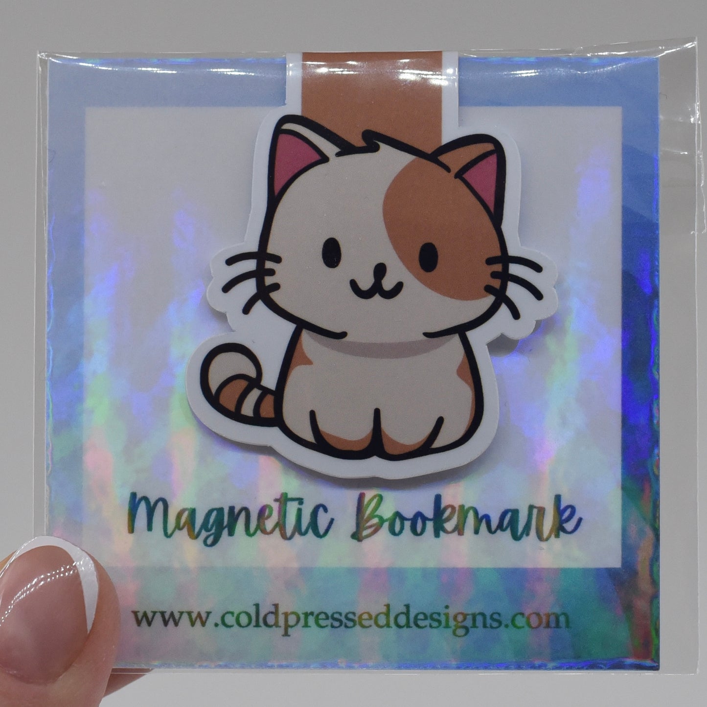 A handmade magnetic bookmark featuring a cartoon image of a happy cat on a glossy background, packaged in a clear plastic sleeve with a reflective surface.