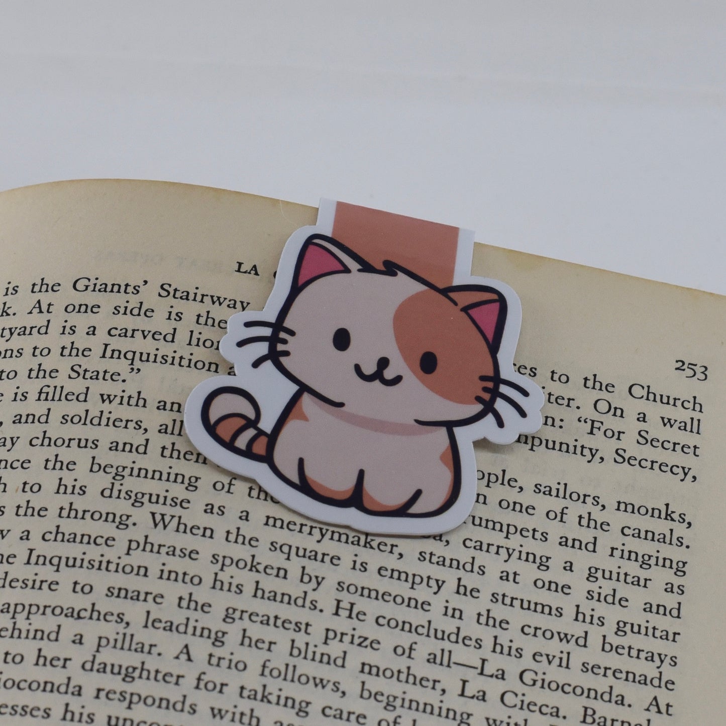A handmade magnetic bookmark featuring a cartoon image of a happy cat on a glossy background.