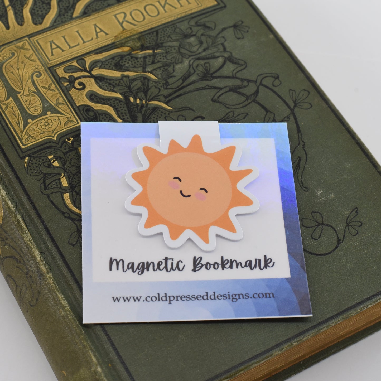 A glossy, double-sided magnetic bookmark in a yellow sun design with a kawaii face.