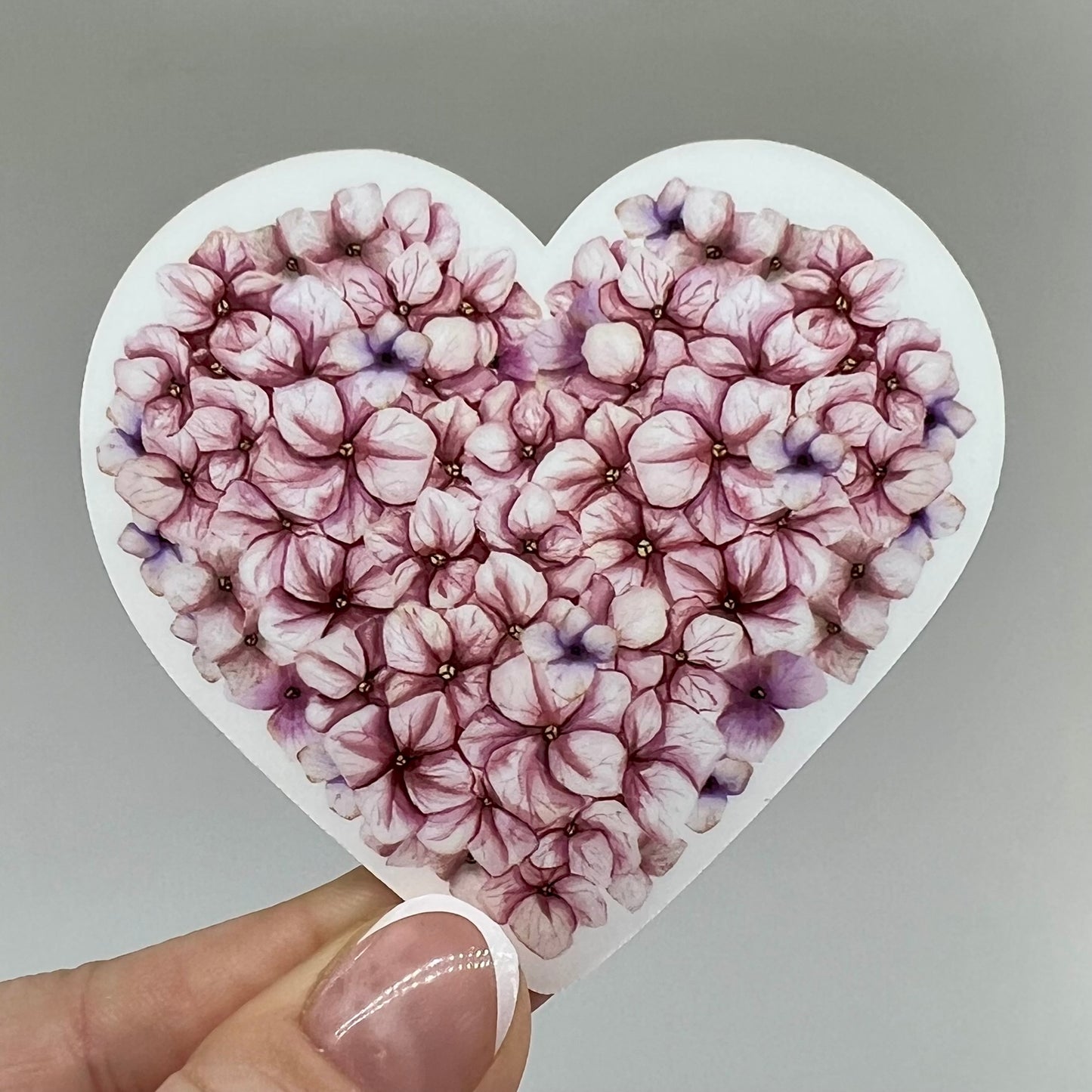 Pink hydrangea flower petals in a sticker vinyl shaped like a heart.