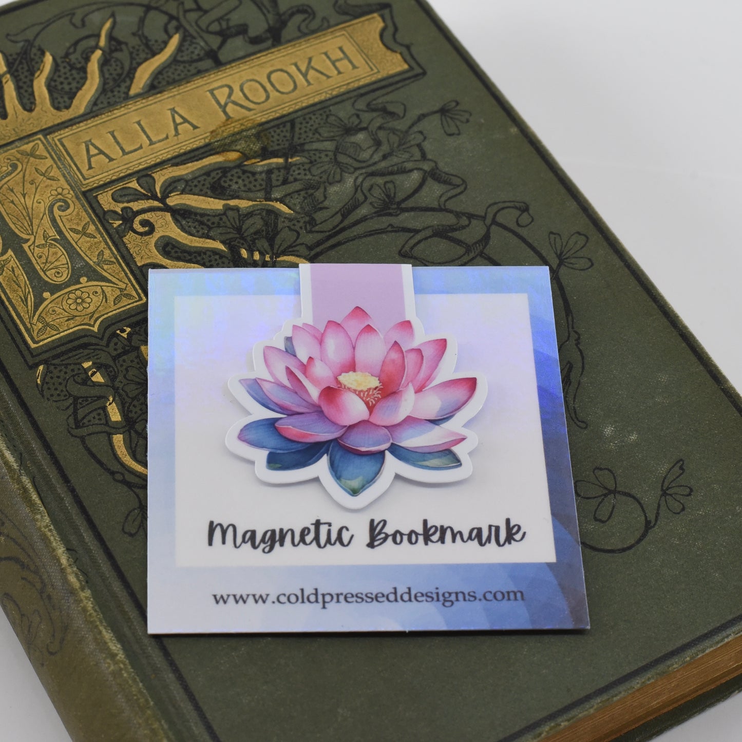 A closed glossy magnetic bookmark with an open pink lotus flower design.