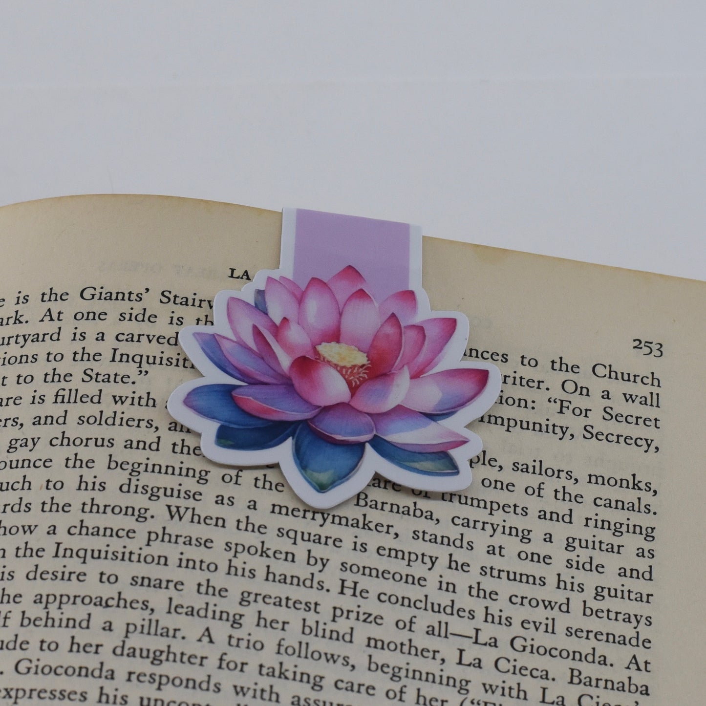 A closed glossy magnetic bookmark with an open pink lotus flower design.