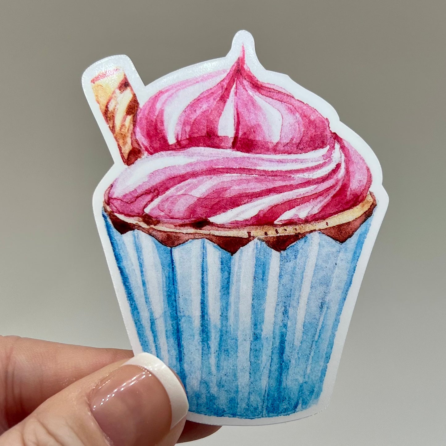 Vinyl sticker of a pirouette garnished cupcake with a blue wrapper.