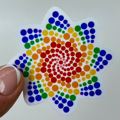 A vinyl sticker shaped like a star with a rainbow of dots of various sizes inside.