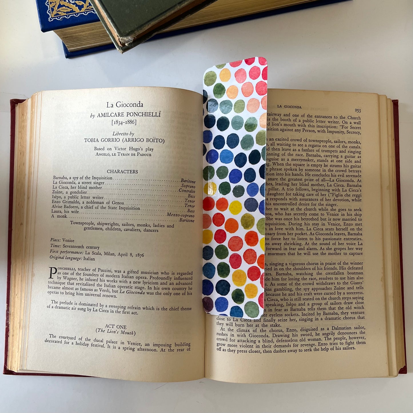 A glossy rectangular bookmark with watercolor dots in a rainbow of colors.