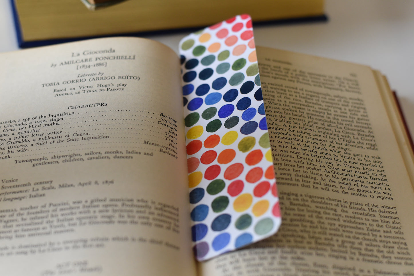 A glossy rectangular bookmark with watercolor dots in a rainbow of colors.