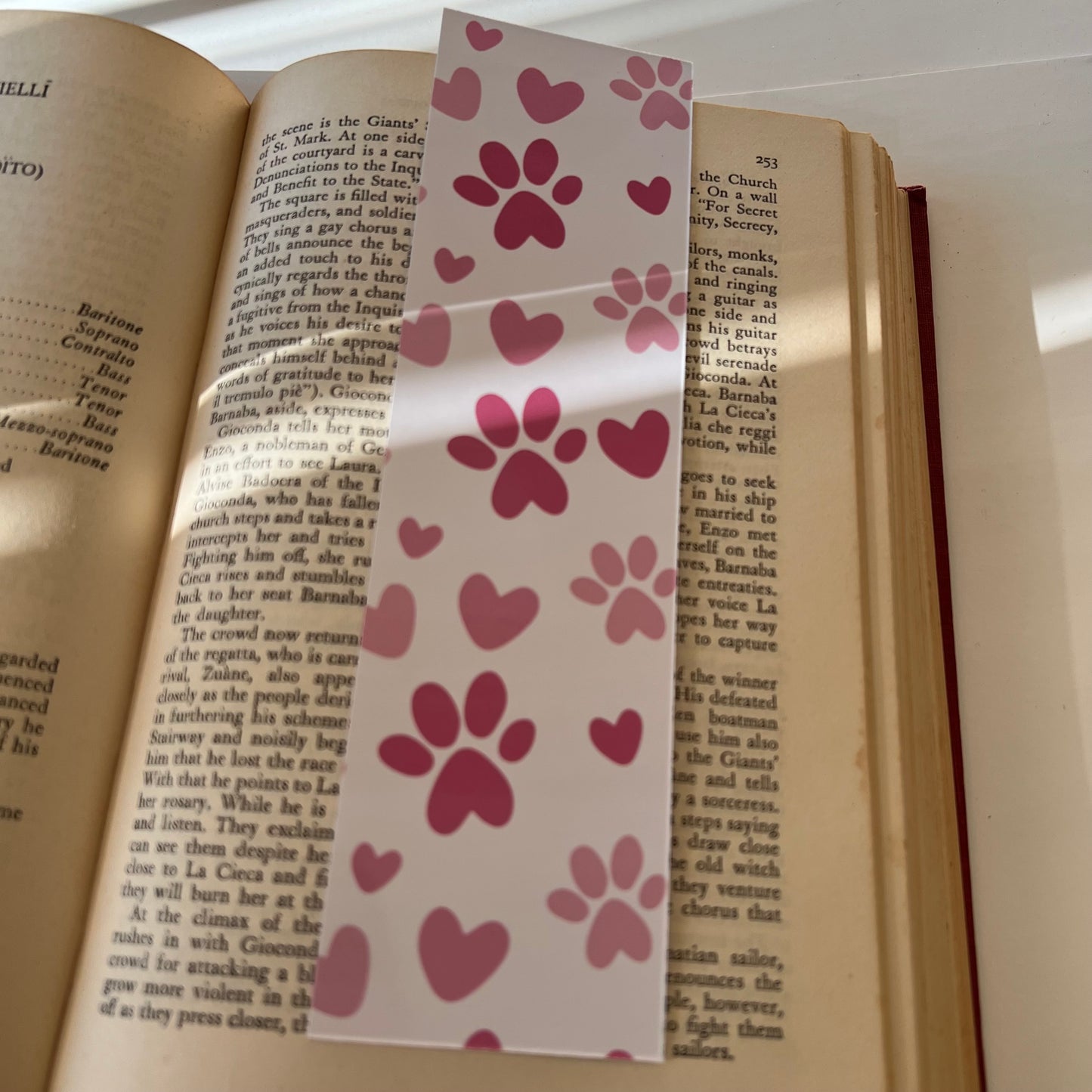 The back side of the rectangular "You Pawsed Here" bookmark with pink pawprint pattern.