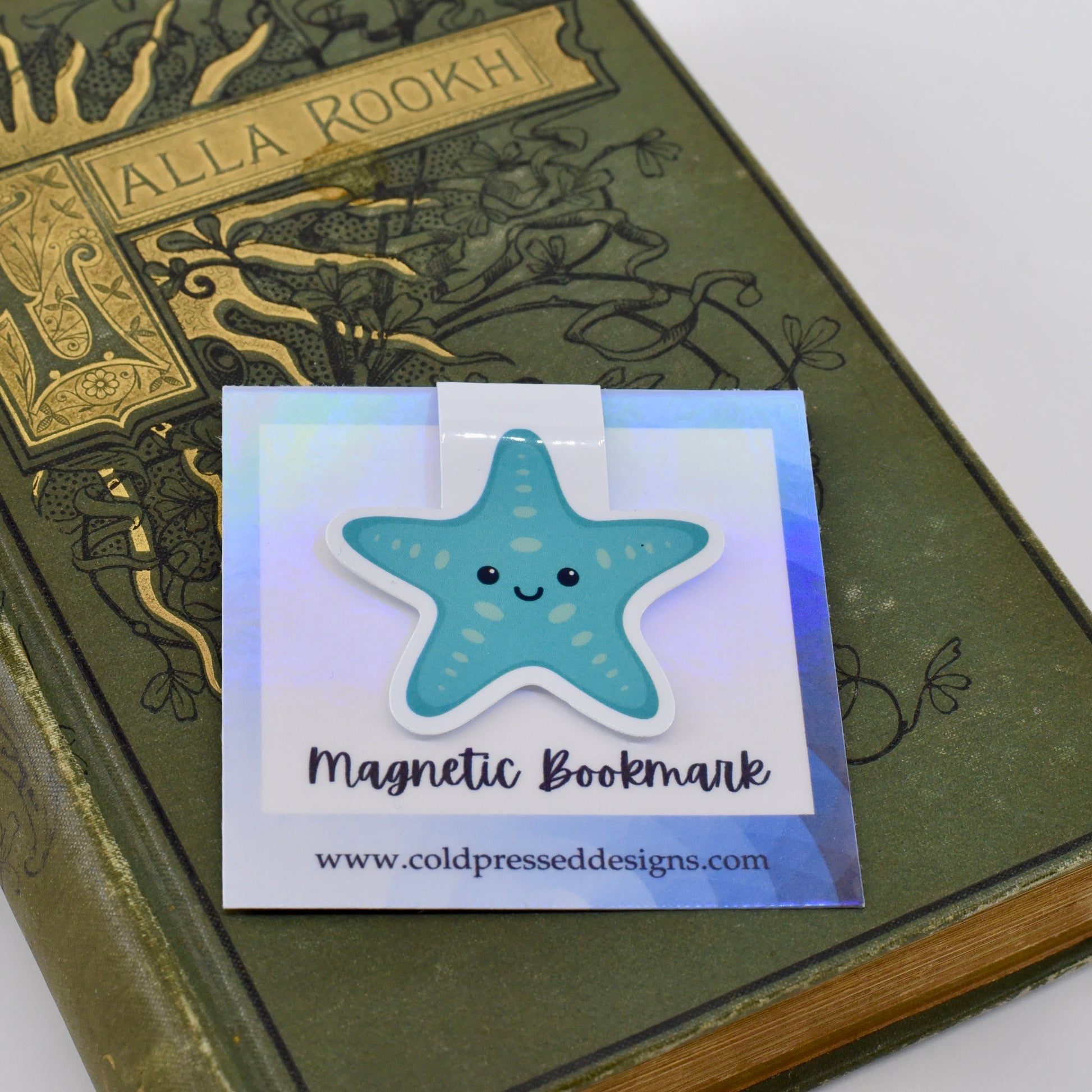 A glossy, magnetic bookmark shaped like a teal blue starfish with a happy kawaii face.