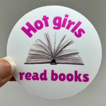 A vinyl sticker with a white background featuring text and an image of an open book. The text reads 'Hot girls read books.'