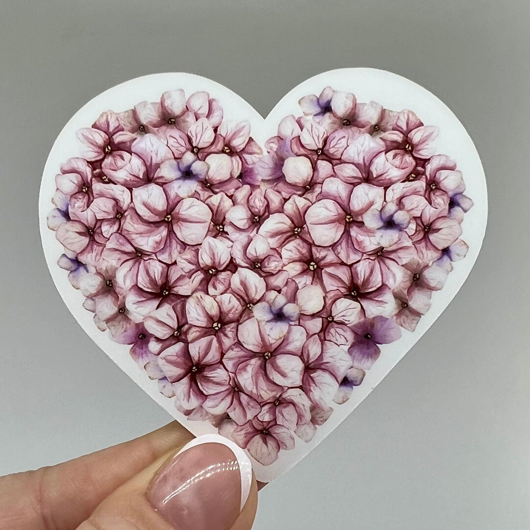 Pink hydrangea flower petals in a sticker vinyl shaped like a heart.