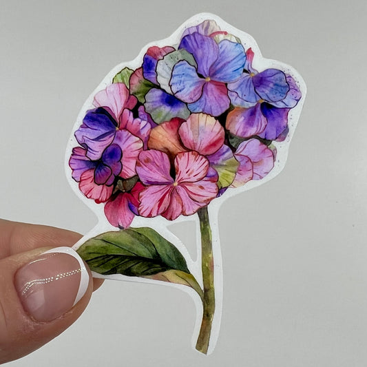 Fingers holding a pink and purple hydrangea sticker