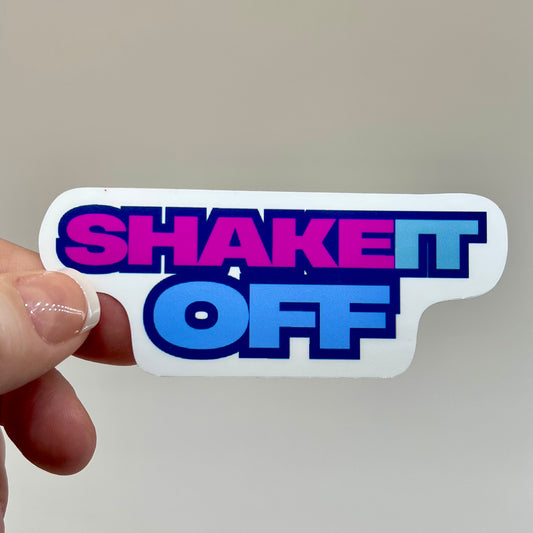 Vinyl sticker with the text 'SHAKET IT OFF' in bold colors of pink and blue.