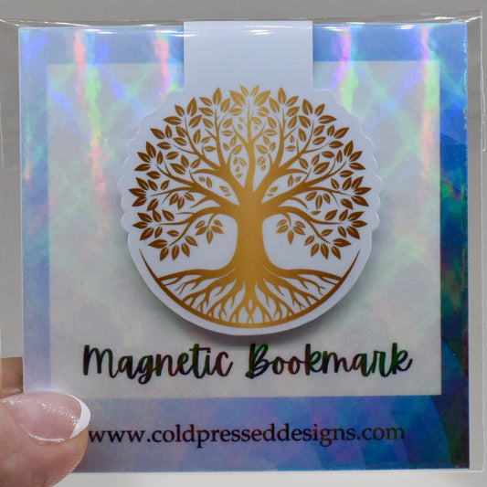 A round, glossy magnetic bookmark with a gold tree of life design, with the brand name 'Cold Pressed Designs' written at the bottom.
