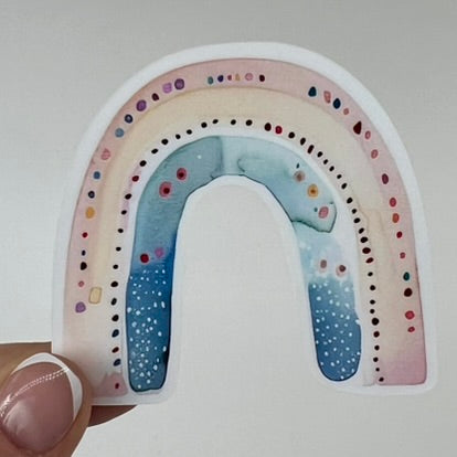 A vinyl sticker with a yellow and blue watercolor rainbow design.